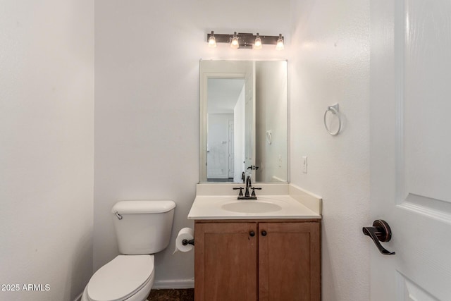 half bath featuring toilet and vanity