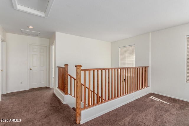 hallway featuring dark colored carpet, recessed lighting, attic access, an upstairs landing, and baseboards