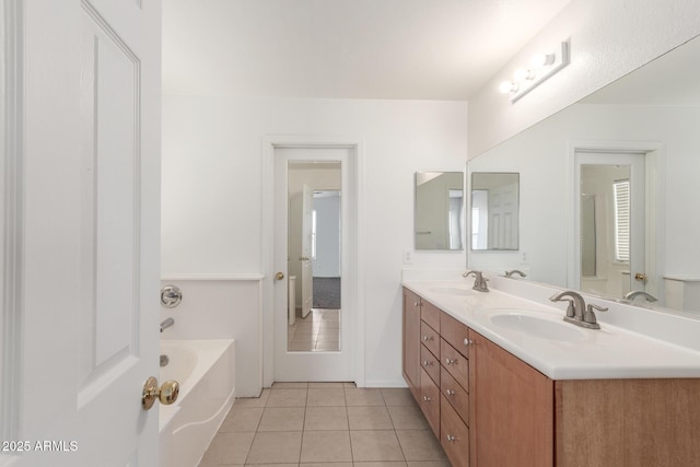 full bath featuring double vanity, a bathing tub, a sink, and tile patterned floors