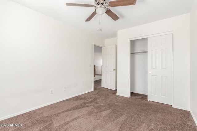 unfurnished bedroom featuring a ceiling fan, dark colored carpet, a closet, and baseboards