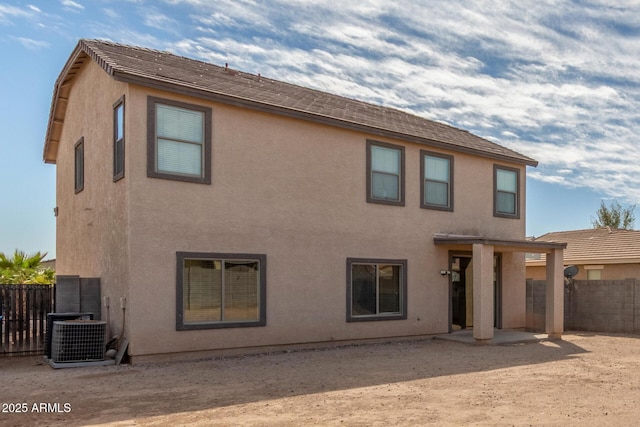 back of house featuring a patio, fence, cooling unit, and stucco siding