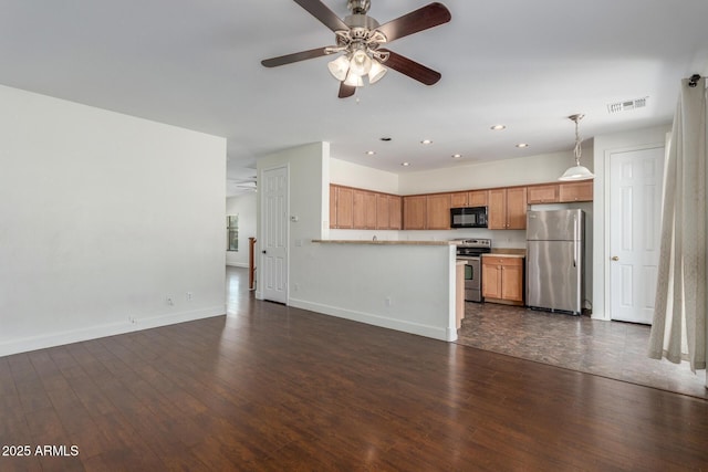 kitchen featuring decorative light fixtures, light countertops, visible vents, appliances with stainless steel finishes, and open floor plan