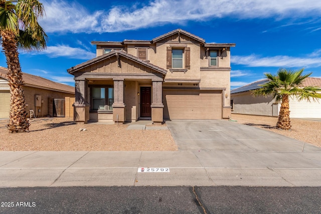 view of front facade featuring a garage, concrete driveway, a tiled roof, and stucco siding