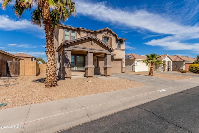 view of front of house featuring a garage, fence, concrete driveway, and stucco siding