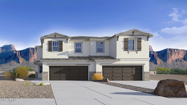 view of front facade featuring a garage and a mountain view