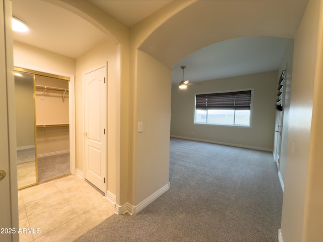 hall with light colored carpet