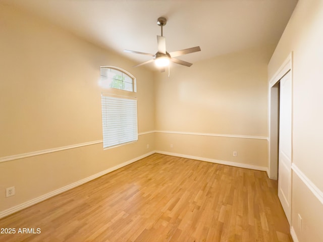 empty room with ceiling fan and light hardwood / wood-style floors