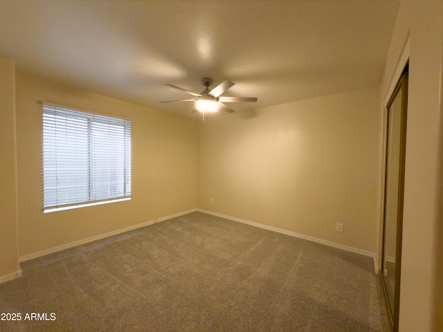 carpeted spare room with ceiling fan