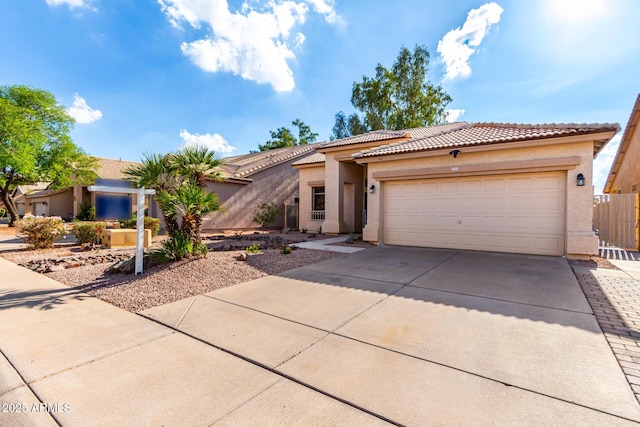 1022 S Butte Ln, Gilbert, AZ 85296 - mediterranean / spanish-style house featuring stucco siding, concrete driveway, a tiled roof, and an attached garage
