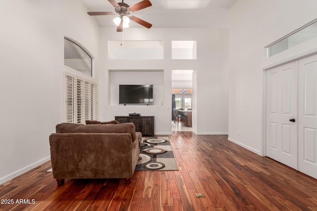 1022 S Butte Ln, Gilbert, AZ 85296 - living room featuring a ceiling fan, wood-type flooring, and a high ceiling