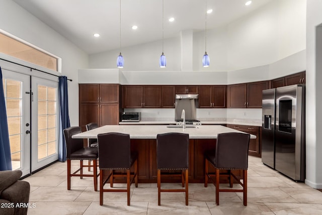 1022 S Butte Ln, Gilbert, AZ 85296 - kitchen with appliances with stainless steel finishes, high vaulted ceiling, light countertops, dark brown cabinets, and a kitchen island with sink