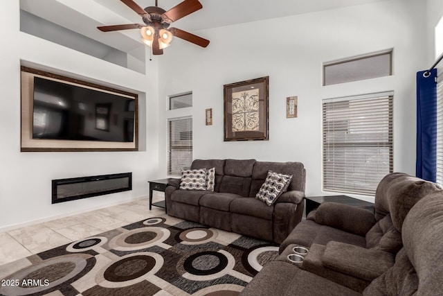 1022 S Butte Ln, Gilbert, AZ 85296 - living room with ceiling fan, marble look tiles, and a glass covered fireplace