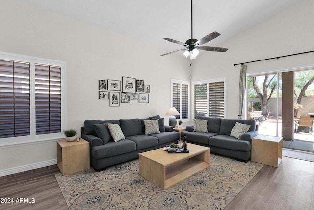 living room with ceiling fan, high vaulted ceiling, and dark hardwood / wood-style floors