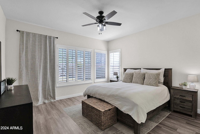 bedroom with hardwood / wood-style floors and ceiling fan