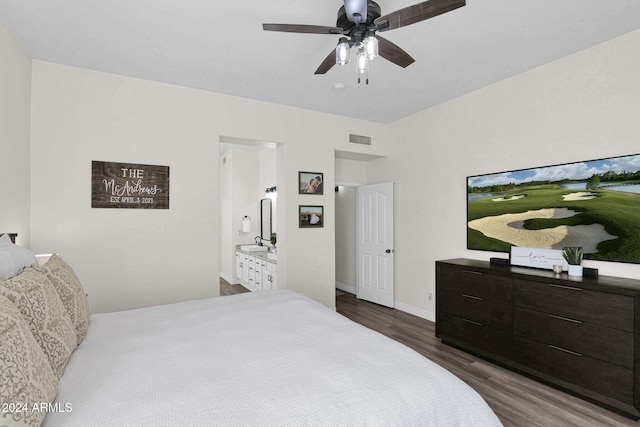 bedroom featuring dark wood-type flooring, ensuite bathroom, sink, and ceiling fan