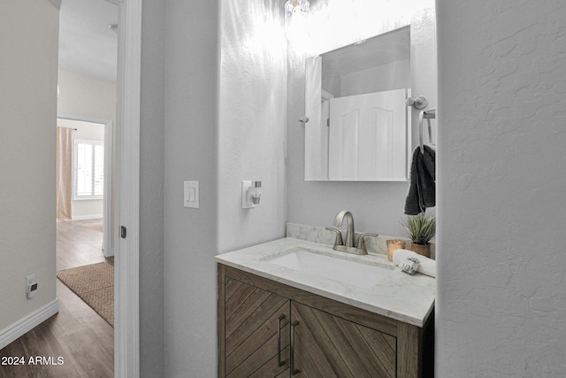 bathroom featuring vanity and hardwood / wood-style floors