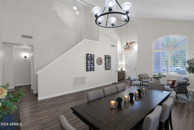 dining room with high vaulted ceiling, dark hardwood / wood-style flooring, and a chandelier