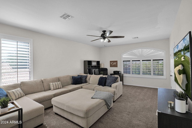 carpeted living room featuring ceiling fan and a healthy amount of sunlight