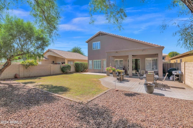 back of property featuring a patio and a yard