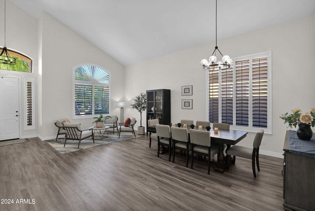 dining space featuring a chandelier, high vaulted ceiling, and dark wood-type flooring