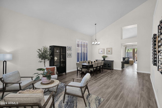 living room featuring an inviting chandelier, dark hardwood / wood-style floors, and high vaulted ceiling