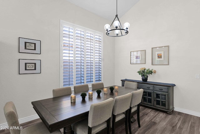 dining room with an inviting chandelier, vaulted ceiling, and dark hardwood / wood-style floors