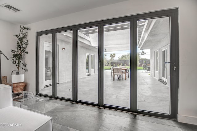 doorway to outside featuring baseboards and visible vents