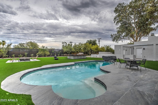 view of pool featuring a patio, fence, a lawn, a fenced in pool, and outdoor dining space