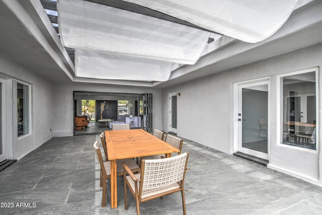 sunroom / solarium featuring beam ceiling