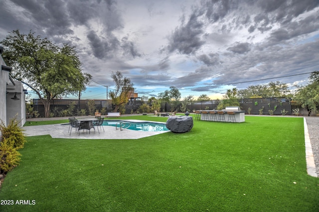 view of swimming pool with a yard, a fenced in pool, a fenced backyard, and a patio