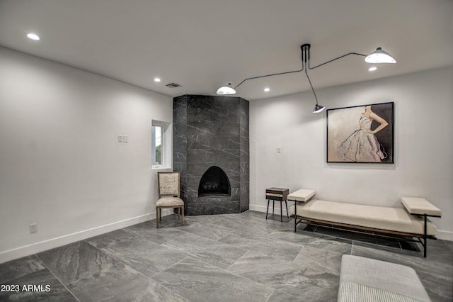 living area featuring marble finish floor, recessed lighting, visible vents, a tile fireplace, and baseboards