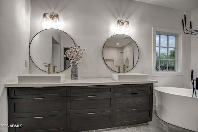 bathroom featuring a freestanding tub, a sink, and double vanity