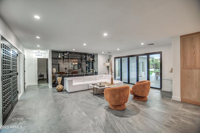 living area featuring baseboards, visible vents, and recessed lighting