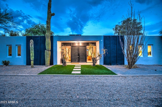 rear view of property with french doors and stucco siding