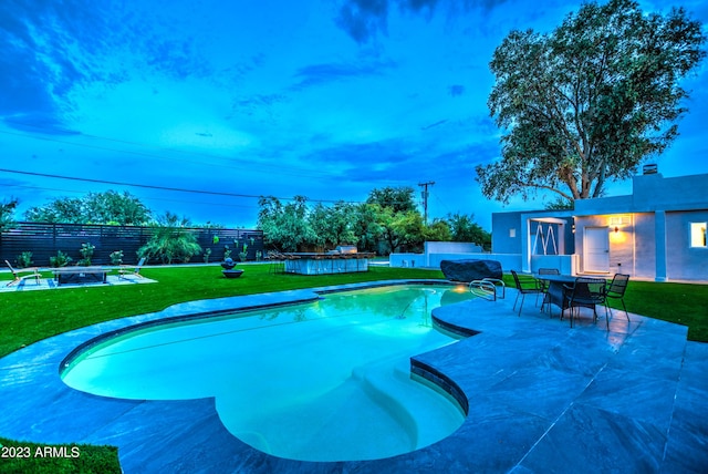 view of pool with a lawn, a patio area, fence, and a fenced in pool