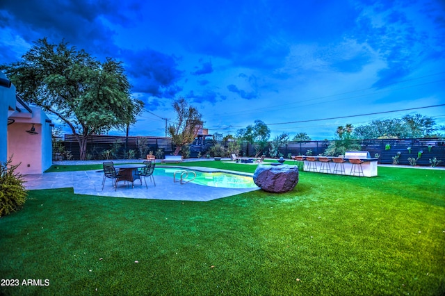 view of pool featuring a patio area, a fenced backyard, a fenced in pool, and a yard