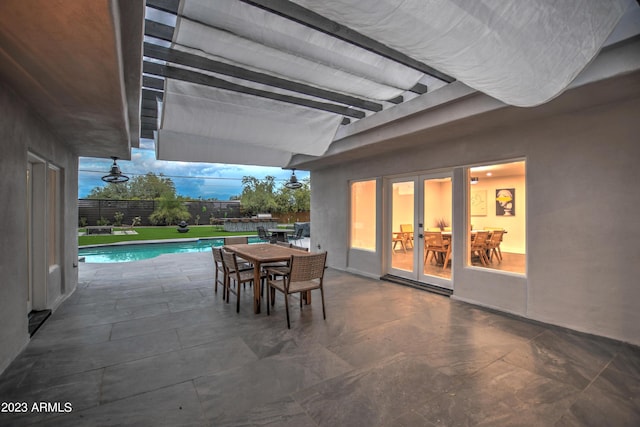 view of patio featuring outdoor dining area and a fenced in pool