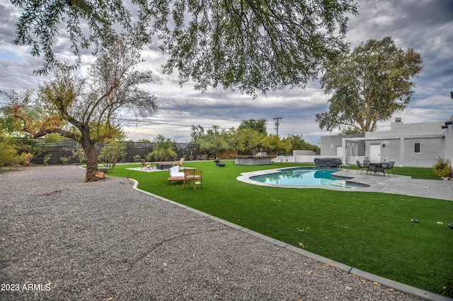 view of swimming pool featuring a patio area, a fenced backyard, a fenced in pool, and a lawn