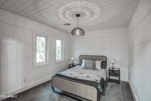 bedroom featuring baseboards and visible vents