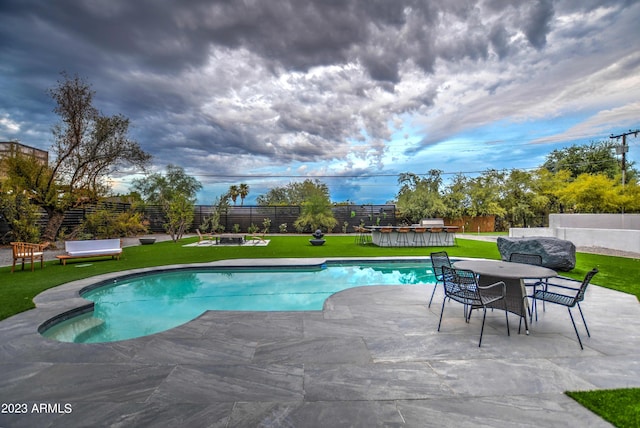 view of swimming pool with a fenced in pool, a patio area, a yard, and a fenced backyard