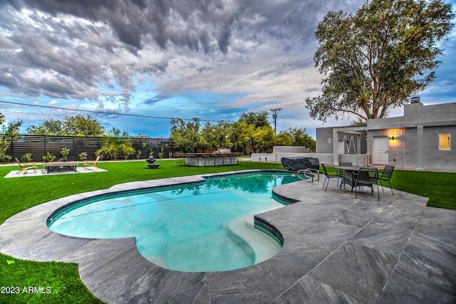 view of swimming pool with a fenced in pool, fence private yard, a patio area, and a yard