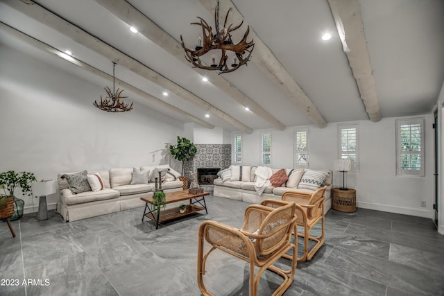 living room featuring vaulted ceiling with beams, a fireplace, baseboards, and a chandelier