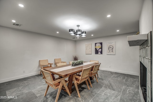 dining space featuring a fireplace, recessed lighting, visible vents, a chandelier, and baseboards