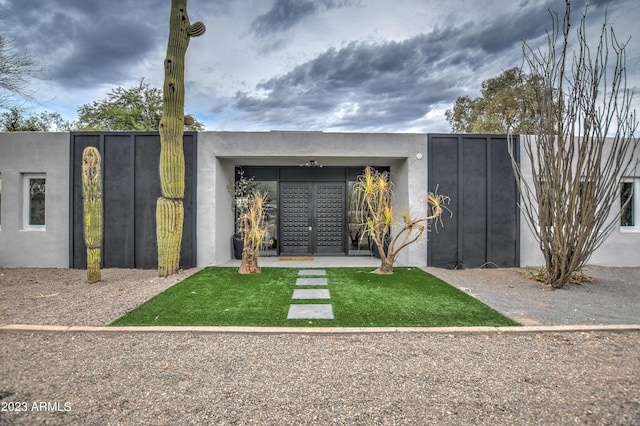 exterior space featuring fence and stucco siding