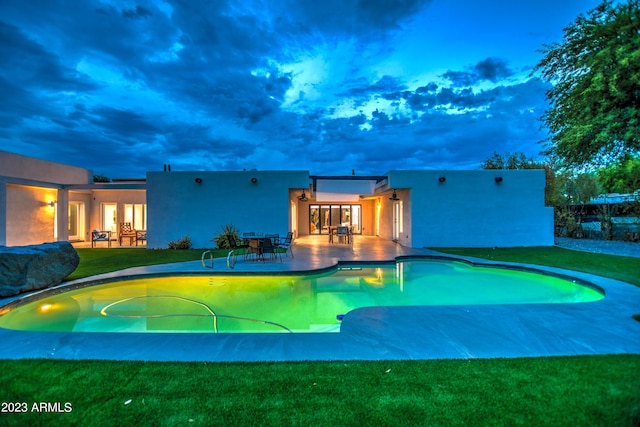 pool with a yard and a patio