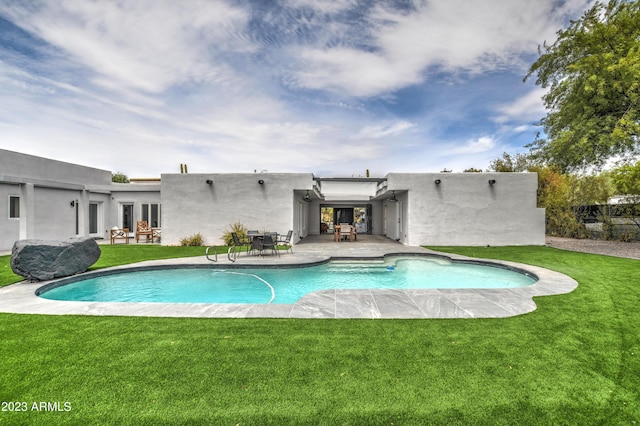 view of swimming pool featuring a fenced in pool, a lawn, and a patio