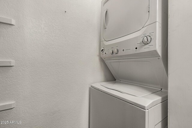 1402 E Guadalupe Rd Unit 234, Tempe, AZ 85283 - washroom with stacked washer / dryer and a textured wall