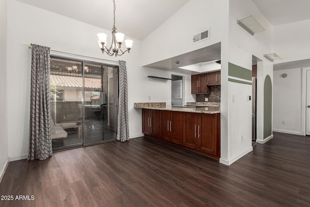 1402 E Guadalupe Rd Unit 234, Tempe, AZ 85283 - kitchen with baseboards, dark wood-type flooring, high vaulted ceiling, a chandelier, and tasteful backsplash
