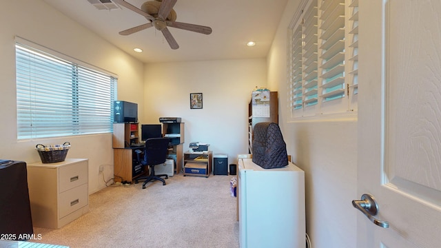 carpeted office space with ceiling fan