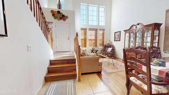 sitting room featuring a high ceiling and light tile patterned floors